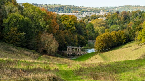A view over the Pasture towards the Palladian Bridge at Prior Park, view of Bath city in the background